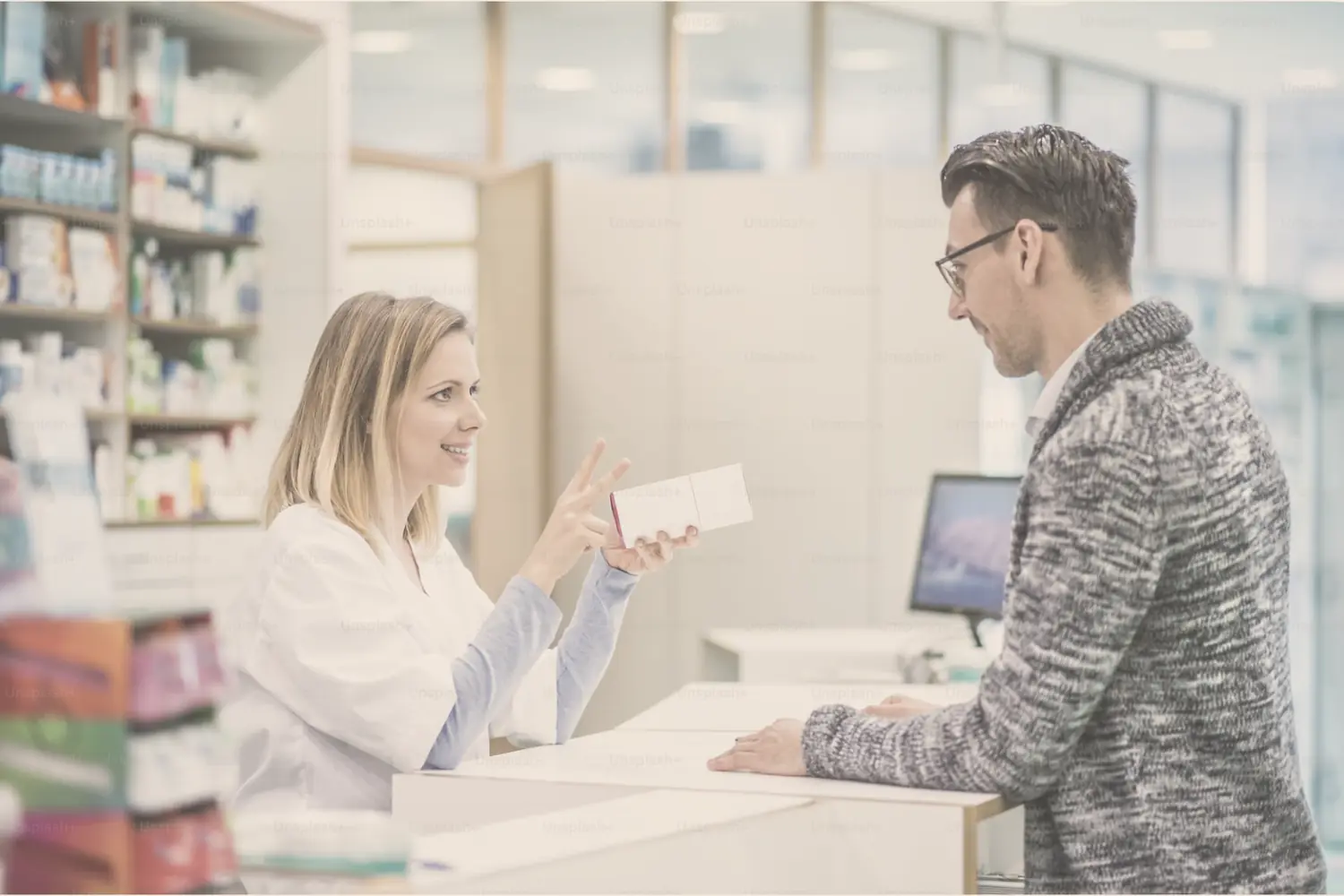 A pharmacist explaining a medication to a customer