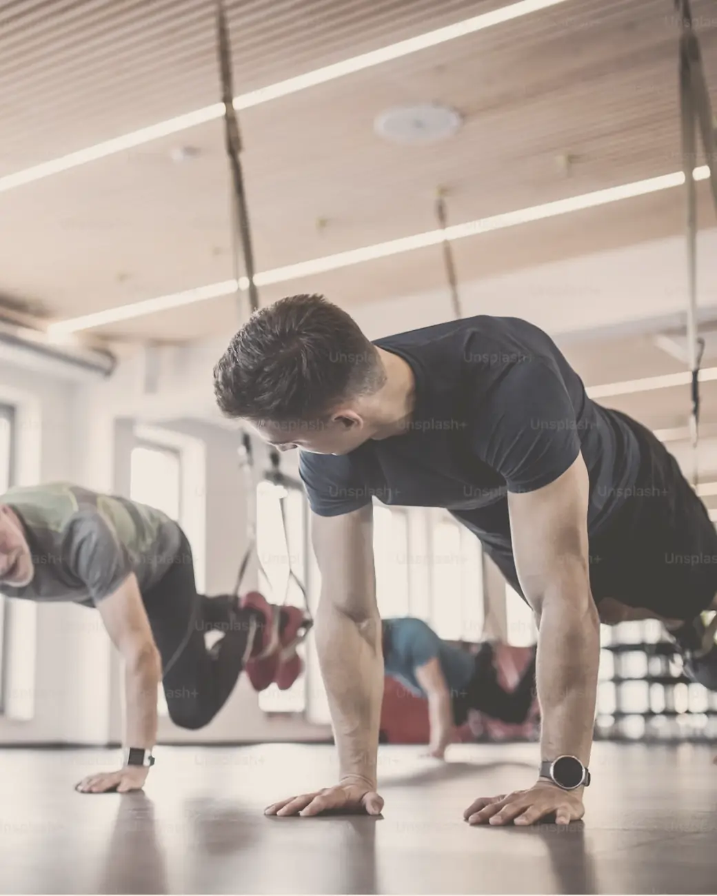 A group class training on suspension straps